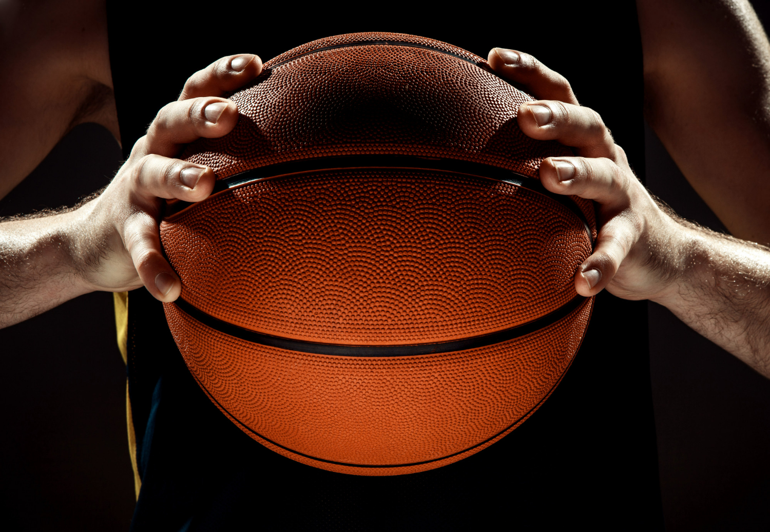 https://teamwinbasketball.com/wp-content/uploads/2023/07/silhouette-view-basketball-player-holding-basket-ball-black-wall.jpg